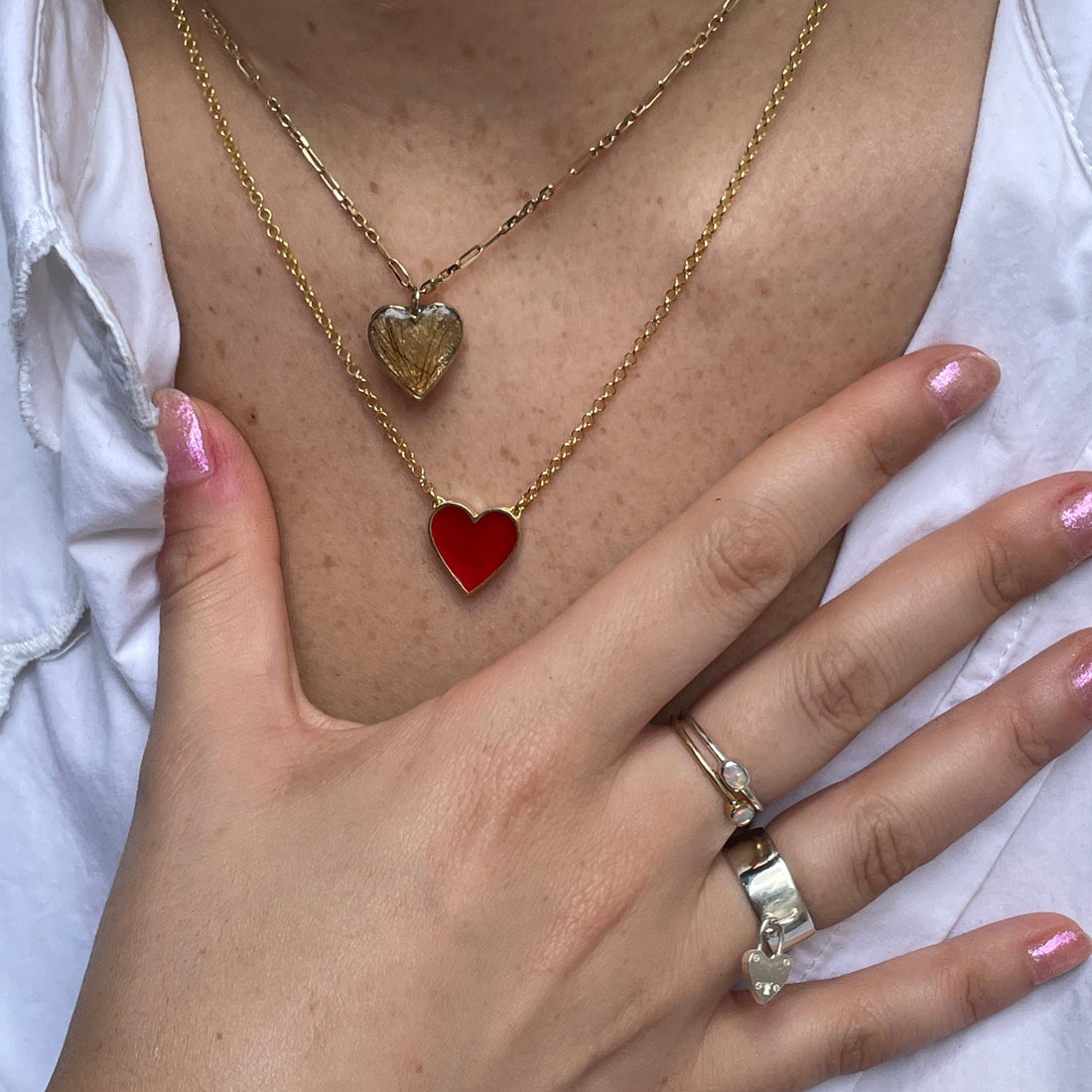 A sterling silver ring with a wisdom tooth set in a crown setting, worn on a hand