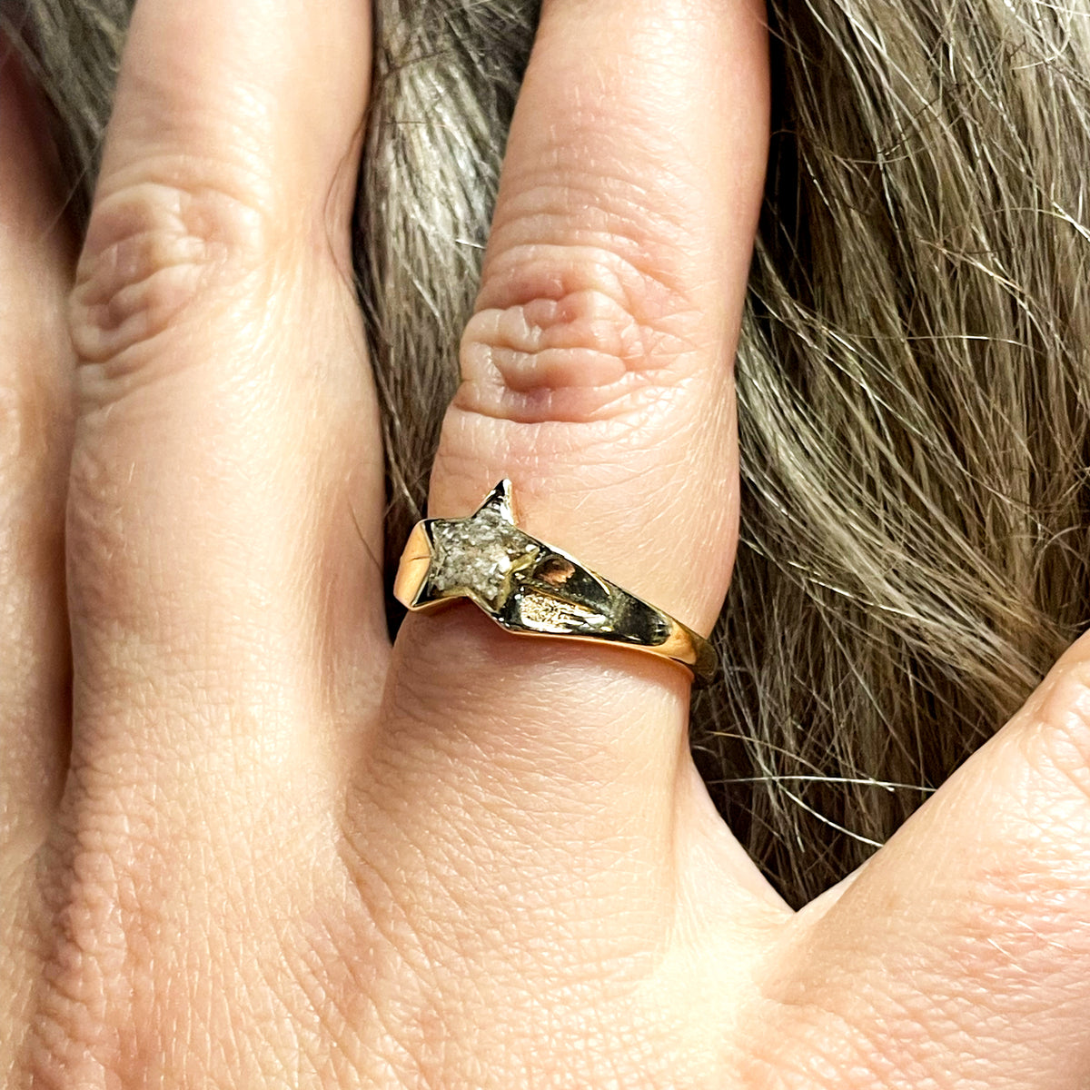 A solid 9ct gold signet ring with cremation ashes sealed under a dark square setting