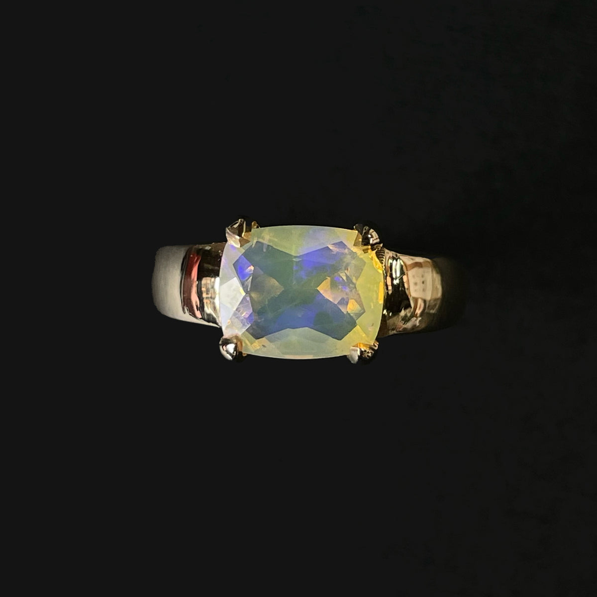 A solid gold heart pendant set with a blue-green boulder opal, on a gold chain