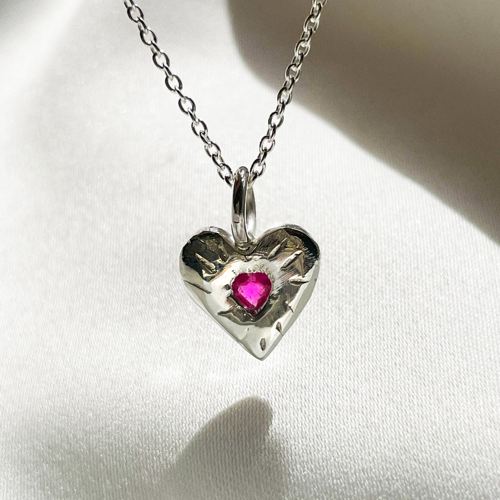 Heart necklace with ruby store in the middle